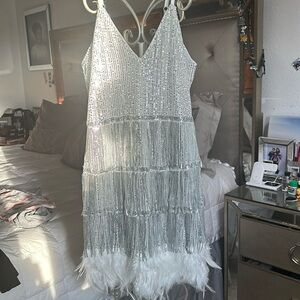 Beautiful sequin dress in silver with white feathers at the bottom size L